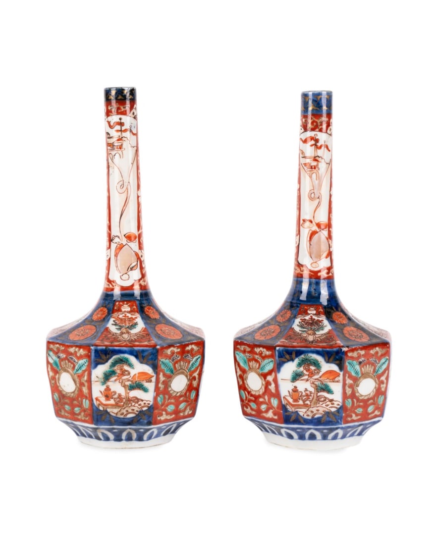 PAIR OF JAPANESE MEIJI PERIOD IMARI VASES: Japanese, Meiji Period, late 19th century. Pair of Imari decorated long neck vases with octagonal shaped body in the traditional palette of iron red, cobalt blue with gilt, apparently unmarked. Approx