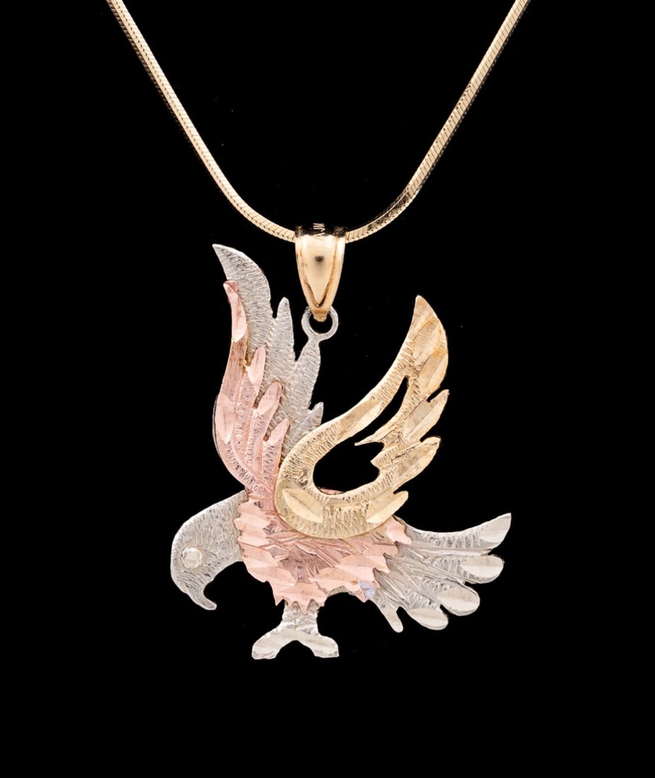 TRI-COLOR GOLD EAGLE PENDANT, 14K YG CHAIN: Tri-color 10-12k gold eagle pendant necklace with openwork on wing, with a 10k yellow gold bail, and held on an Italian 14k yellow gold chain. Pendant unmarked but testing between 10k to 12k, bail and