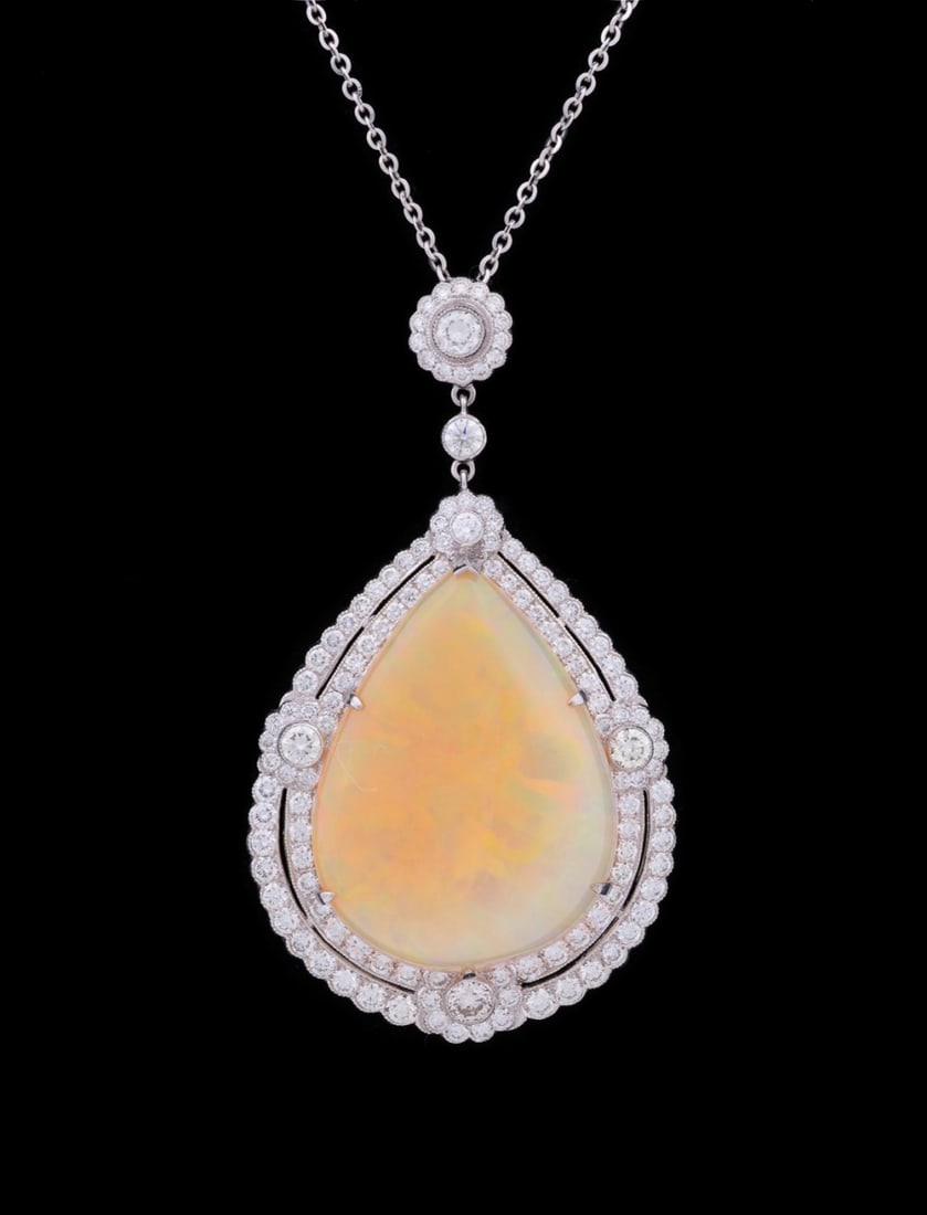 LARGE OPAL AND DIAMOND NECKLACE, 18K WHITE GOLD: Opal and diamond pendant with chain featuring (1) pear shaped opal weighing approximately 45-50 total carats surrounded by full cut diamonds weighing approximately 7.50 total carats set in 18K white g