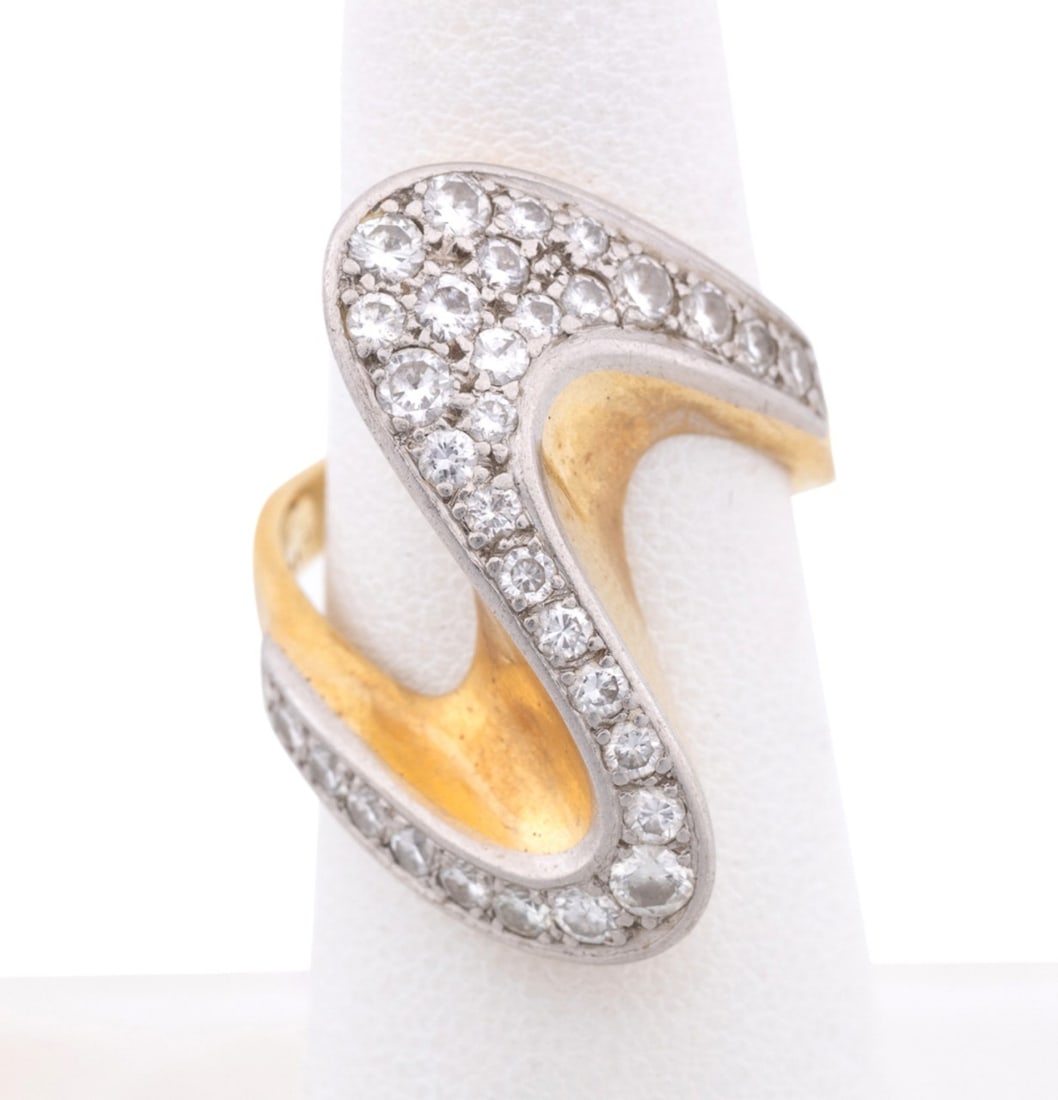 CELLINO, MODERN DIAMOND 18K YG RING: Cellino (Italian, founded 1970's). Modern "S" form ring with (30) round brilliant cut diamonds set in white gold within a yellow gold band, overall diamond weight approximately 0.90 total carats. Set