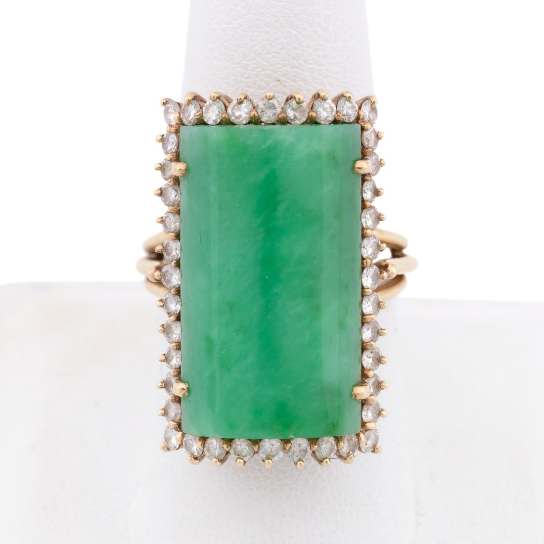 JADE & DIAMOND 14K YG COCKTAIL RING: Jade and diamond ring centering on a square cabochon jade (approximately 23.5 x 14.1 x 4.0 mm) surrounded by (40) round cut diamonds with a diamond weight of approximately 1.60 total carats. Set in 14