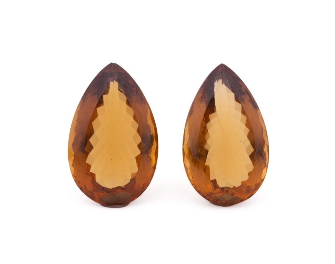 TWO LARGE LOOSE PEAR SHAPE CITRINE GEMSTONES: Two large loose pear shape faceted citrine stones weighing approximately 122.50 total carats. Approximate dimensions: h. 1.375", w. 0.875", total weight 24.5 grams. Note: Note: Direct credit card paym