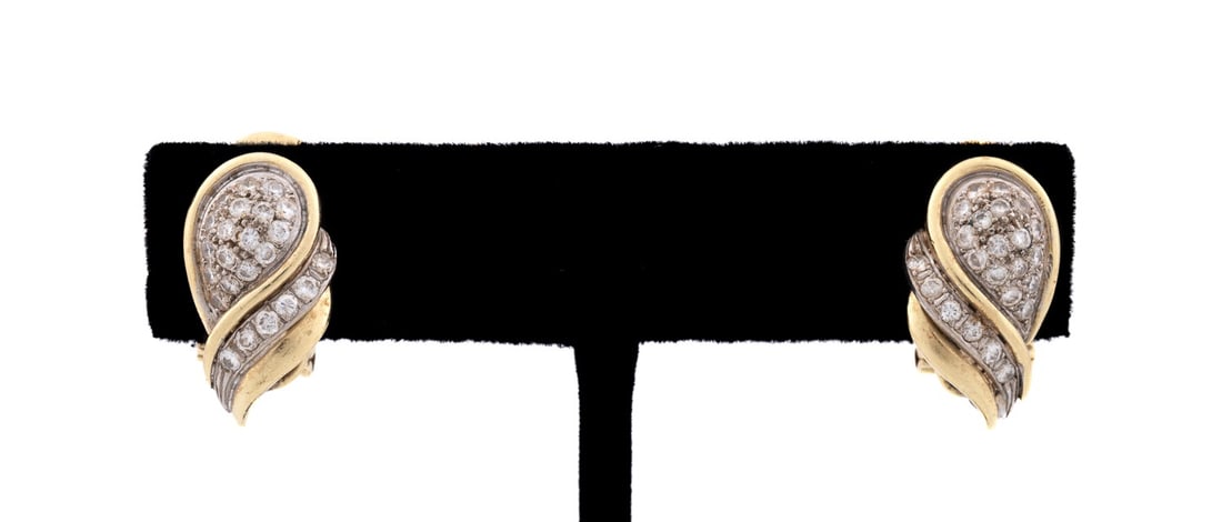 DIAMOND SWIRL 18K YELLOW GOLD EARRINGS: Pair of diamond teardrop swirl earrings, each earring with (23) round cut diamonds set in white gold within polished yellow gold board with a diamond weight of both earrings approximately 0.92 total c