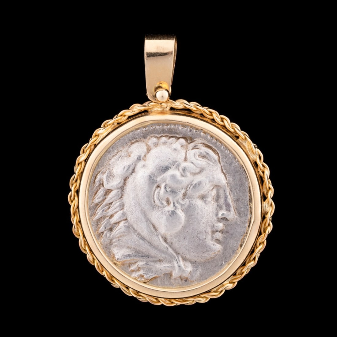 ALEXANDER THE GREAT COIN SET INTO 18K YG PENDANT: Alexander the Great (Greece, (Macedonia), 356-323 BC). Tetradrachm coin mounted into 18k yellow gold bezel, obverse is Heracles wearing the headdress of the Nemean Lion, and the reverse is Zeus. Appar
