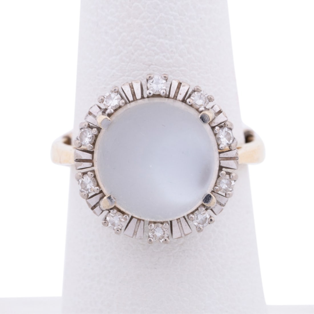 MOONSTONE AND DIAMOND 18K GOLD RING: Moonstone and diamond gold ring featuring a center round cabochon moonstone measuring approximately 11.1 x 11.1 x 5.6mm, surrounded by (10) round cut diamonds weighing approximately 0.30 total carats,