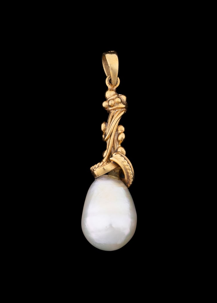 CULTURED WHITE PEARL & 18K YELLOW GOLD PENDANT: White pearl teardrop shape pendant with white cultured pearl measuring approximately 18.0mm, suspended from intricately swirled and ball detail 18K yellow gold mount. Marked '"18K". Provenance: The