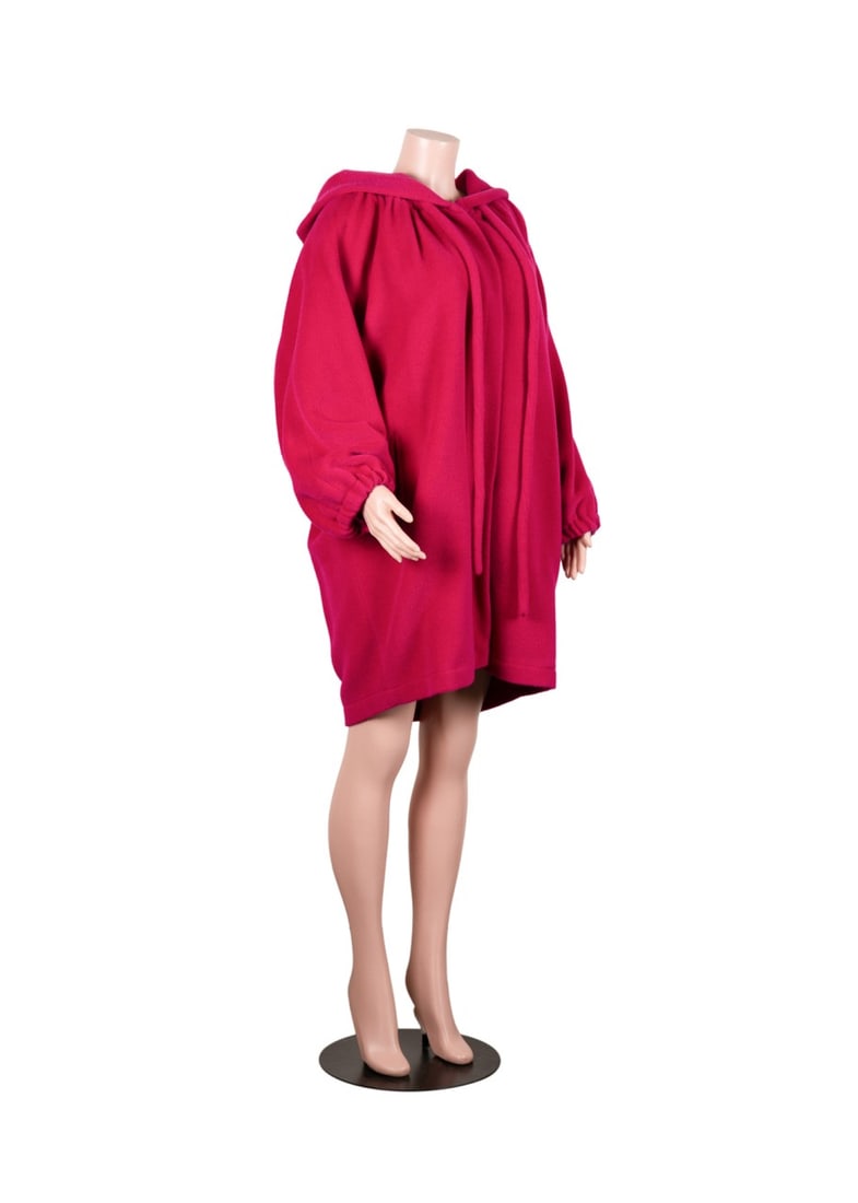 CHRISTIAN LACROIX HOT PINK ALPACA AND WOOL COAT: Christian Lacroix (French, founded 1987). Oversized fuschia coat with front snap button closures, hood, two front pockets, and drawstring detail. Made of alpaca and wool, lined with acetate and rayon.