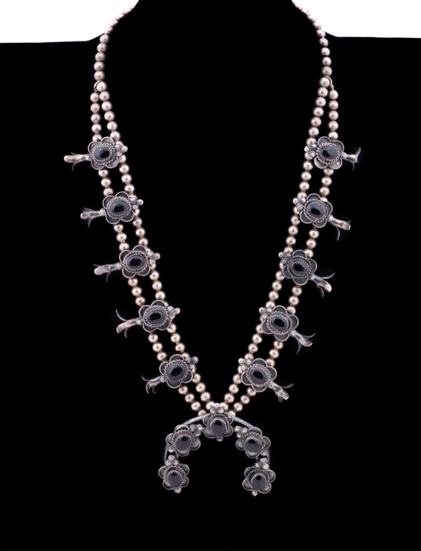 NAVAJO BLACK ONYX STERLING SQUASH BLOSSOM NECKLACE: Vintage Navajo black onyx squash blossom necklace, having black cabochon set stones and a horseshoe form pendant, stamped "sterling" to back of pendant. Provenance: Private Collection, Brookhaven, GA.