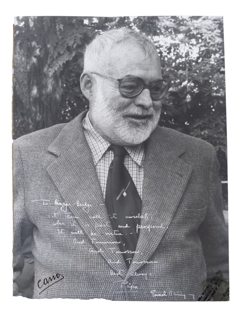 ERNEST HEMINGWAY SIGNED AND INSCRIBED PHOTOGRAPH: Ernest Hemingway (American, 1899-1961) signed black and white portrait photograph, inscribed and signed "To / let them call it mischief, / when it is past and prospered, / it will be virtue. - / And t