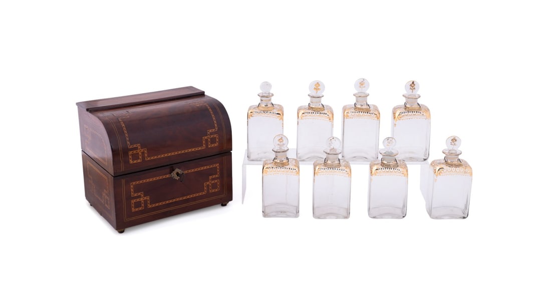 GEORGE III MAHOGANY LIQUOR CASE AND DECANTERS: English, early 19th century. George III or Regency mahogany veneer liquor case or cave a liquor, having mixed wood parquetry inlay, eight gilded colorless glass decanters and eight Belgian, Dutch, or