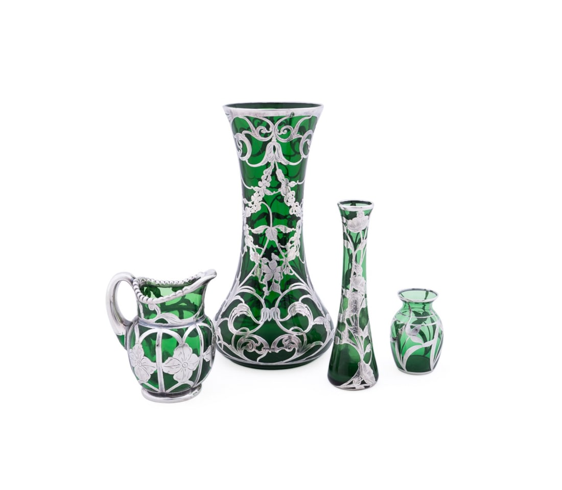 FOUR .999 SILVER OVER GREEN GLASS TABLE ARTICLES: Various manufacturers (American), late 19th to early 20th century. Collection of four Art Nouveau .999 / sterling silver over green glass tabletop items comprising, a tall vase, a Gorham Mfg. Co. (Ame