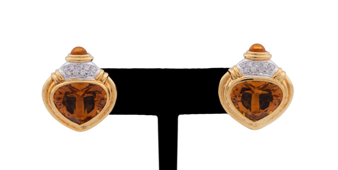 CITRINE, DIAMOND AND 18K YG EARRINGS: Pair of citrine, diamond and 18k yellow gold earrings featuring a triangular faceted citrine (13 x 15 x 8.0mm) bezel set stepped yellow gold, accented above by (9) round cut diamonds weighing approxim
