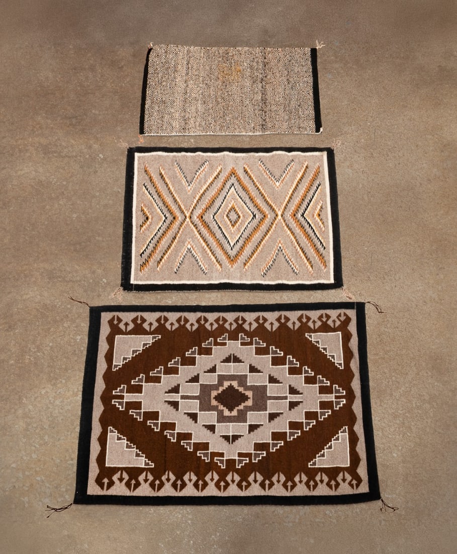 THREE HANDWOVEN NAVAJO TEXTILES, SALINA DALE RUG: Native American, late 20th century. Group of three handwoven Navajo rugs comprising one Two Grey Hills rug by weaver Salina Dale (born 1935) having a medium grey field with a brown, dark grey, white,