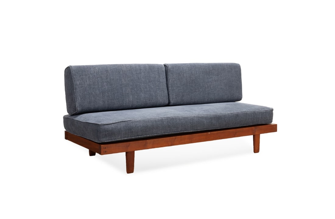 GEORGE NAKASHIMA, C. 1956 BLACK WALNUT DAYBED: George Nakashima (American, 1905-1990), circa 1956. Classic daybed in walnut, having upholstered cushions and raised on ovoid legs, USP date stamp "January 27, 1956" to underside of plywood. Provenanc