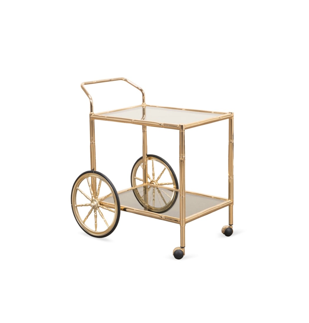 HOLLYWOOD REGENCY BRASS & GLASS ROLLING BAR CART: French or Italian, mid 20th century. Hollywood Regency two tier brass and glass drinks or bar cart, having bamboo motif frame, apparently unmarked. Approximate dimensions: h. 29.25", w. 27", d. 19.5 (