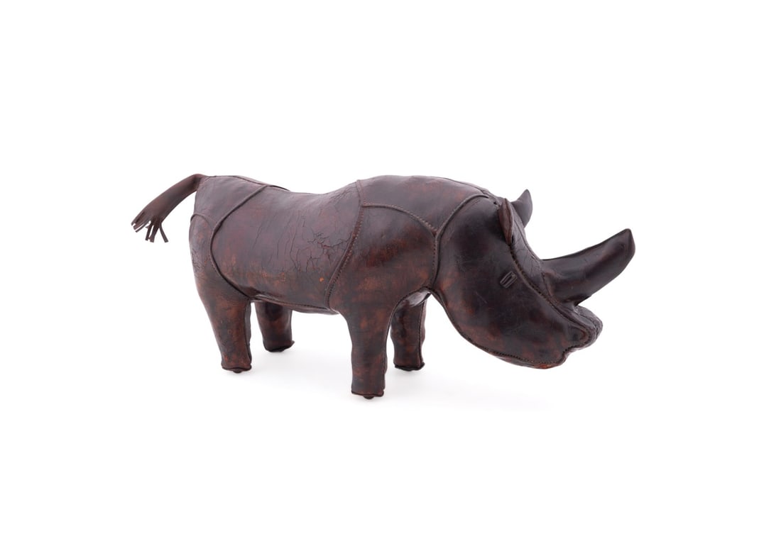 OMERSA FOR ABERCROMBIE LEATHER RHINOCEROS: Omersa (English, founded 1927) for Abercrombie and Fitch (American, founded 1892), before 2017. Brown leather footstool in the form of a standing rhinoceros, apparently unmarked. Provenance: Private