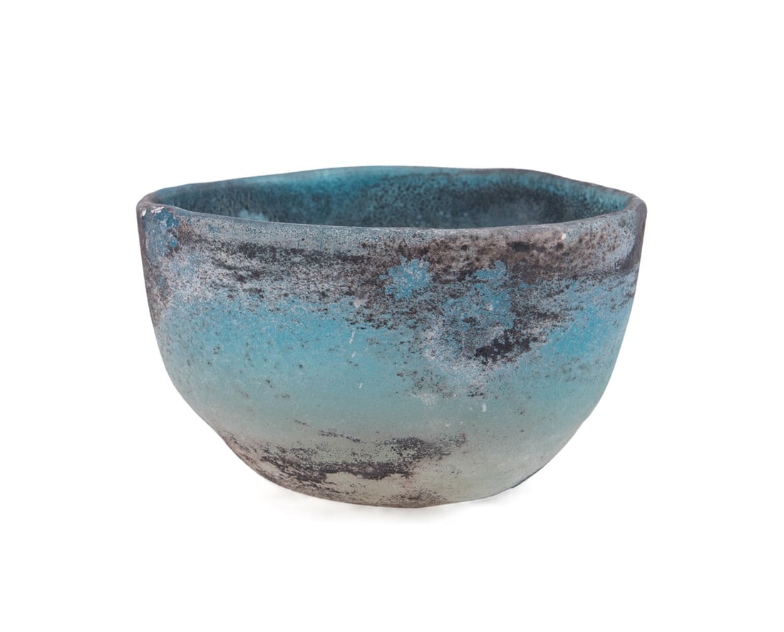 ANCIENT STYLE BLUE CAST SCAVO GLASS BOWL: Ancient style blue cast glass bowl, having a scavo surface, apparently unmarked. Provenance: Estate of Mary Boyle Hataway, Atlanta, GA. Approximate dimensions: h. 3.75", dia. 6".