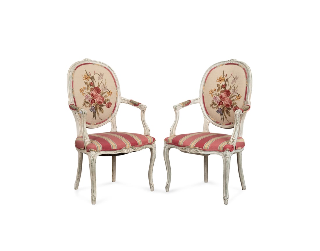 Pair of Louis XV Floral Needlepoint Armchairs: Pair of Louis XV Style Floral Needlepoint Armchairs Late 20th Century, Possibly French Pair of distressed painted armchairs in the Louis XV taste, each having an oval back with floral needlepoint, str