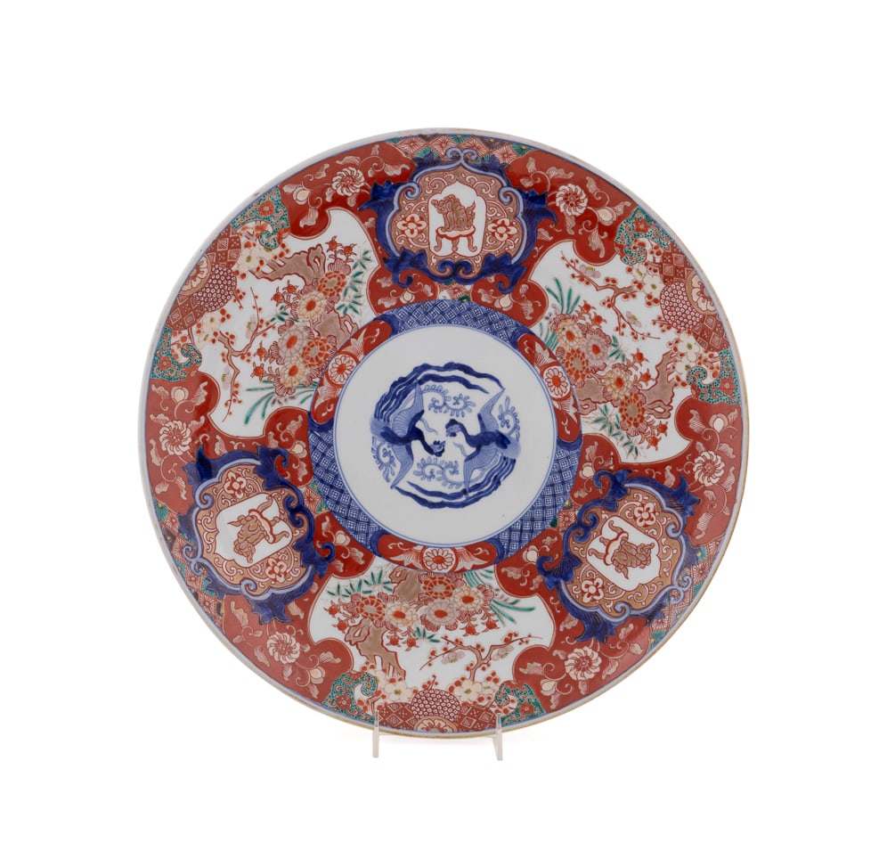 Japanese Large Imari Double Phoenix Charger, Japanese: Japanese Large Imari Double Phoenix Charger Japanese Having alternating reserves decorated with Buddhist guardian lions and florals, encircling two blue and white phoenixes, with similar blue and whit