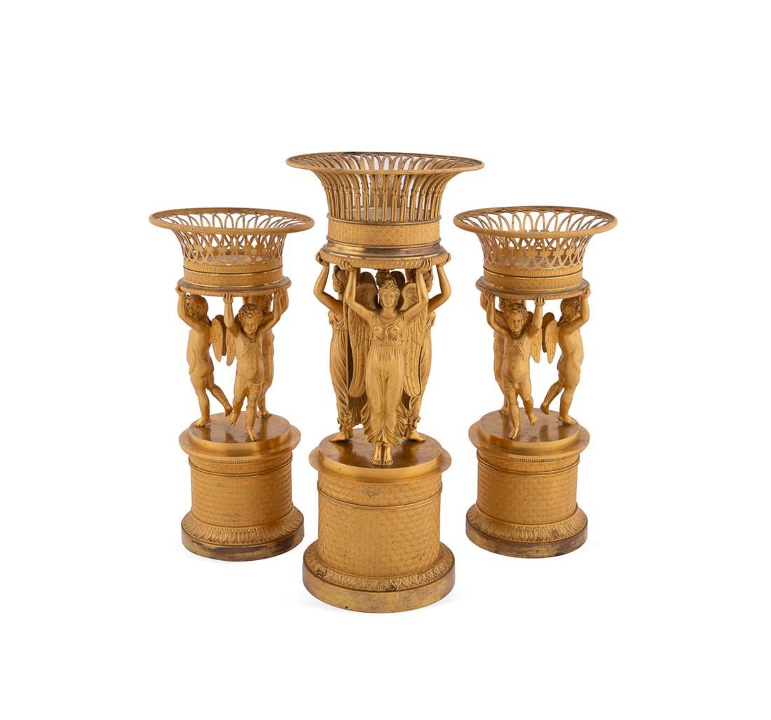Three Piece Empire Style Ormolu Garniture Set: Three Piece Empire Style Ormolu Garniture Set Manner of Pierre-Philippe Thomire (French, 1751-1843) or Deniere et Matelin (French, 1797 - 1820), 19th/20th century. Near three piece gilt bronze corbeil
