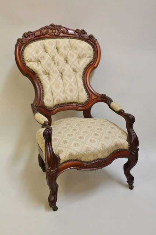 19th C. Mahogany Framed Open Armchair: Victorian style with floral and scroll carved crest, finger carved frame with cabriole legs, cream fabric and button tufted back - 38"H x 22 1/4"W x 19 1/2"D, seat height 15" .