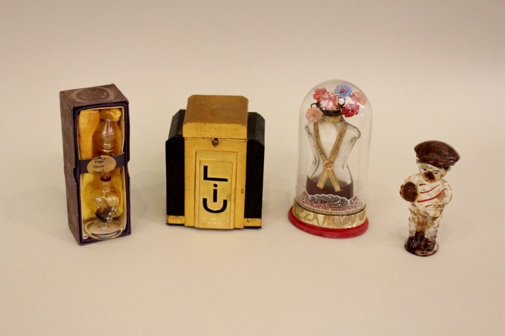 Group of 4 Perfume Bottles: Guerlain Jij black glass bottle in fitted box; R. Expo Copal Perfume in blown glass bottle, "Opium" in original box; Shaiparelli dress form bottle with seamstress tape, in original packaging; figural