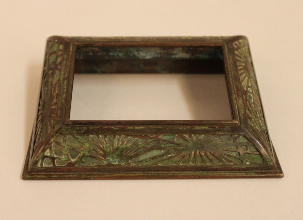 Tiffany Studios Pine Needle Desk Calendar Frame: Bronze composition with verde patina and green slag glass1 1/4"H x 4 1/2"W x 6 3/4"D Provenance: A fine Atlanta Estate