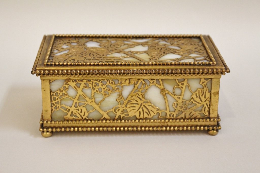 Tiffany Studios Grapevine Box: Signed Tiffany Studios New York , #813, grape vine filagree top & sides backed with amber & ivory slag glass - 3"H x 6 3/4"W x 4"D. Provenance: A Fine Atlanta Estate Overall goo