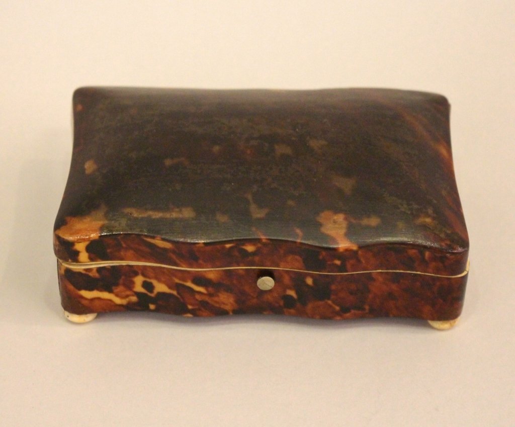 Rectangular Tortoise Jewelry Box with Bone Trim: and ivory feet. 1 1/2"H x 5"W x 3 1/4"D. some restoration.