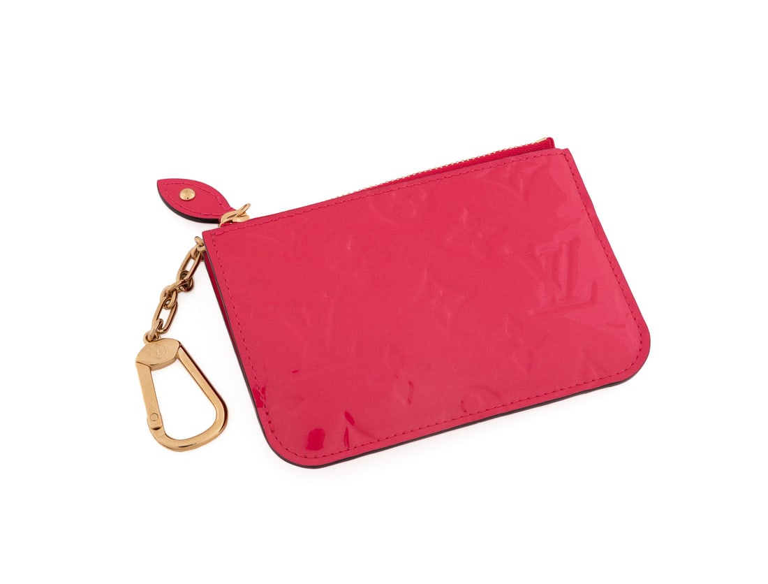Louis Vuitton Patent Leather Card Wallet: Louis Vuitton (French, founded 1854). Hot pink card holder / wallet with embossed LV logos, gold tone hardware, zip top closure, front exterior pocket, and chain with lobster claw key ring affixed to 