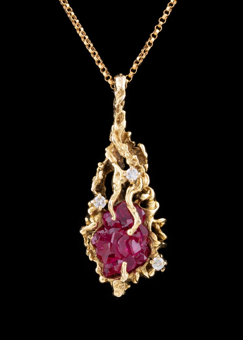 14K Yellow Gold, Ruby and Diamond Necklace: Pendant featuring a freeform faceted ruby within a rustic branching yellow gold teardrop shaped pendant accented by three round cut diamonds with an approximate total diamond weight of .15 carats, on 