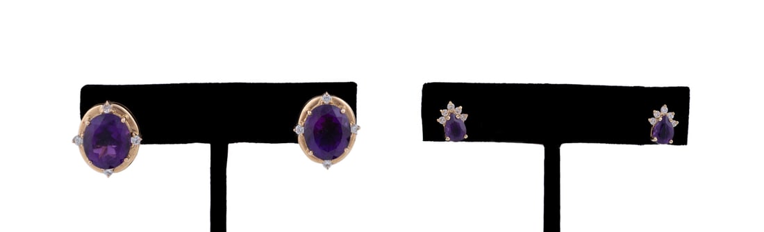 2 Pairs of 14K YG, Amethyst and Diamond Earrings: One pair featuring a pear shaped amethyst weighing approximately .58 carats below three petite round cut diamonds each approximately .03 carats, and one pair centering on an oval cut amethyst weighing