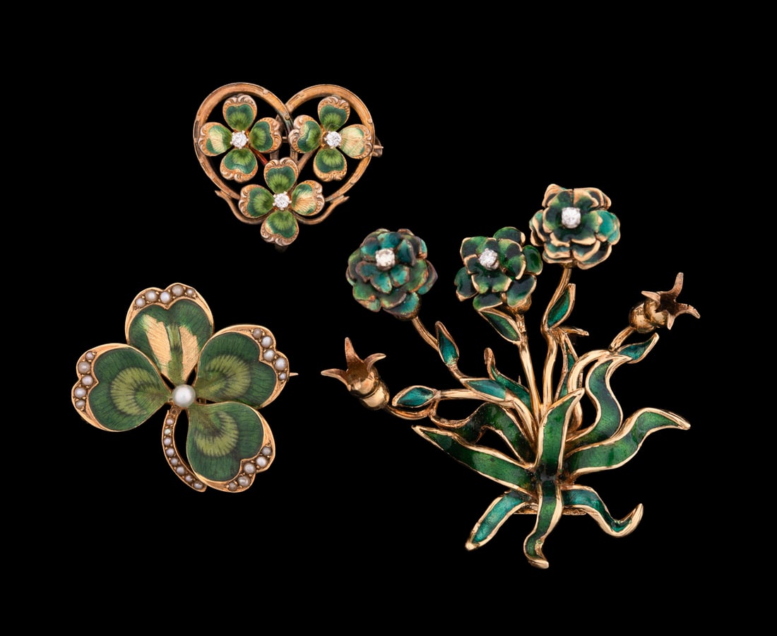 Three Yellow Gold and Green Enamel Pins: Including one 14K yellow gold heart shaped pin displaying three green enamel four leaf clovers each with a single petite round cut diamond center, one 14K yellow gold and green enamel four leaf clover