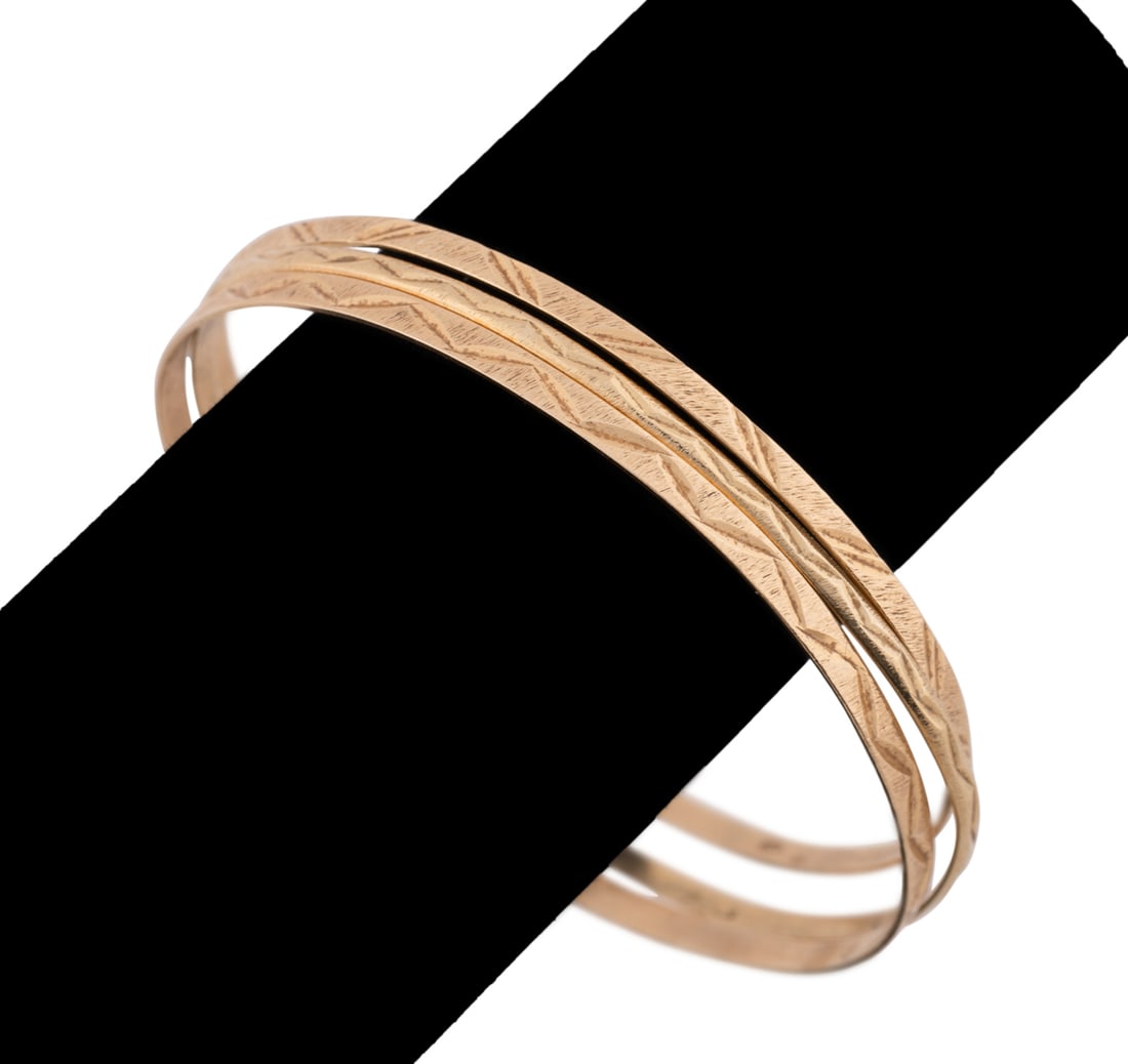 Three 14K Yellow Gold Bangles: Having etched geometric zigzag motif. Two stamped with hallmarks and all three stamped 14k. Acid tested as 14k. Approximate dimensions: Interior circum. 7.75 in. total weight 14.49 grams. Provenance: 