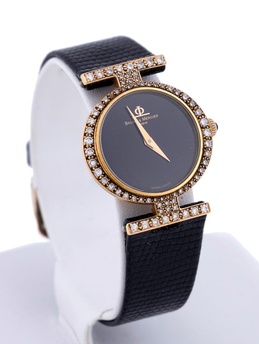 Baume & Mercier, Diamond Wrist Watch Ref. 36618: In 18k yellow gold with a diamond case and lugs, and black leather band, featuring manual wind movement, black dial and gold dauphine hands. Several maker's marks, stamped 750 gold hallmark and "50 / 