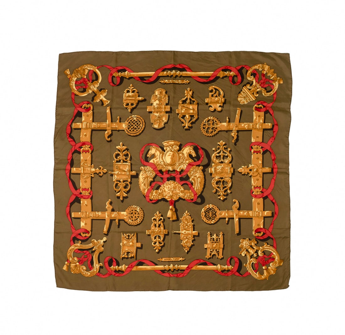 Hermes, "Ferronnerie" Silk Scarf: Cathy Latham for Hermes (French, founded 1837). "Ferronnerie" silk scarf in khaki, red, and gold, originally designed in 1970, appropriately marked, without original care tag. Approximate dimensions: 