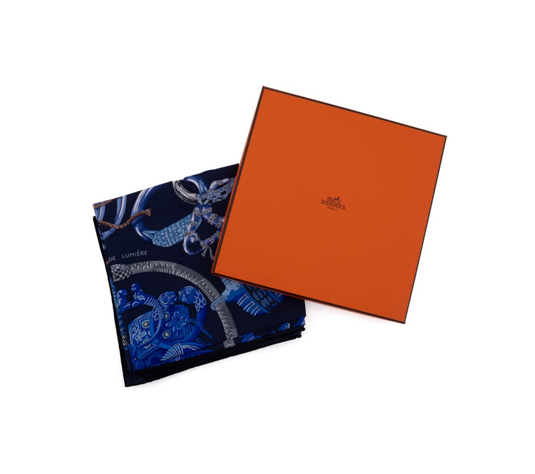 Hermes, "Bracelets de Lumiere" Silk Scarf: Annie Faivre for Hermes (French, founded 1837). "Bracelets de Lumiere" 100% silk scarf in navy blue, appropriately marked, with original care tag, with orange Hermes box, inscribed "New York, 2018" to