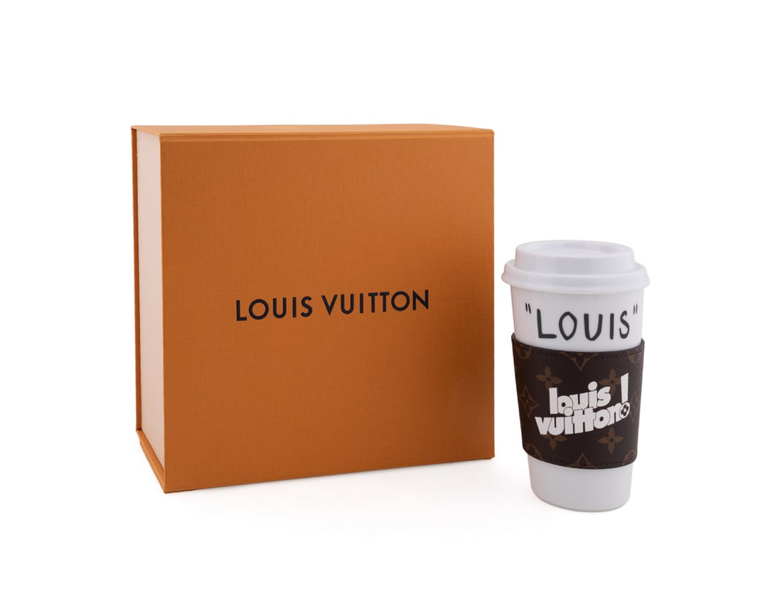 Louis Vuitton, "Louis" Coffee Cup & Sleeve: Louis Vuitton (French, founded 1859), circa 2021. Having a porcelain cup and lid with Monogram sleeve, in fitted branded box. Appropriately marked. Approximate dimensions: 7 x 4 x 4 in. (17.8 x 10.2 x