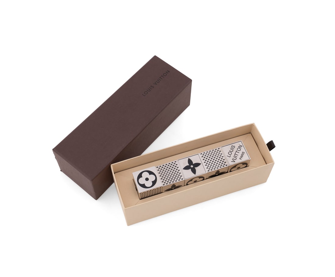 Louis Vuitton, Five Piece Magnetic Dice Game: Louis Vuitton (French, founded 1859), circa 2011. Having a chrome and enamel finish, in branded box. Appropriately marked. Approximate dimensions: 1 x 1 x 1 in. (2.5 x 2.5 x 2.5 cm.)