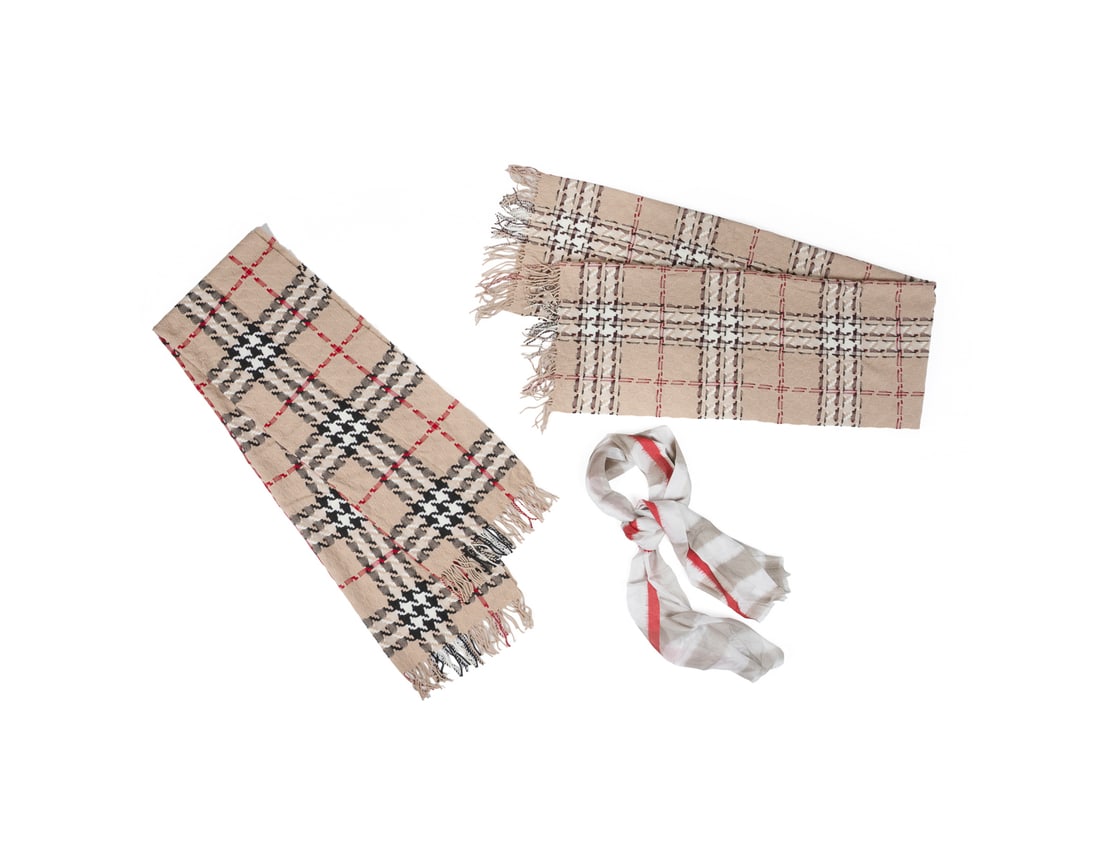 3 Burberry Scarves, 2 Wool/Cashmere & 1 Silk: Burberry (British, founded 1856). Comprising two beige scarves with black, white, and red check, both 90% merino wool and 10% cashmere, and one white and red 100% silk scarf, all with original brand l