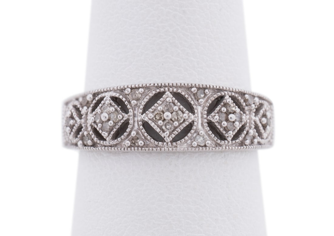 0.21CTW Diamond 14K WG Filigree Band Ring: Apparently unmarked. Tested as 14k. Approximate dimensions: US ring size 4.75; total weight 2.35 grams. Note: Direct credit card payment will not be accepted for this Lot. Accepted payment methods