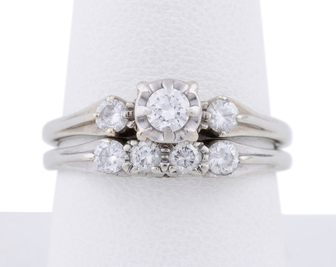 Vintage Orange Blossom 2PC Diamond Wedding Set: Comprising an accented solitaire, having three round diamonds weighing approx. 0.34 total carats and band ring with four round cut diamonds weighing approx. 0.34 total carats. Both stamped "Orange