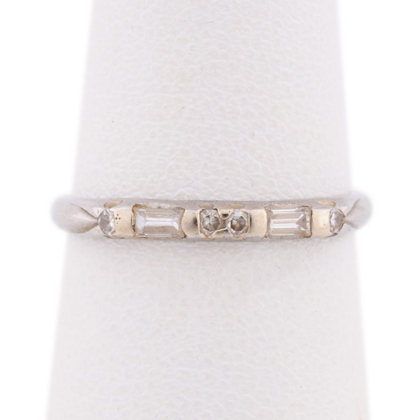 Platinum and Diamond Band Ring: Displaying four bezel set round cut diamonds interspersed by two bezel set baguette cut diamonds, with a total diamond weight of approximately .20 carats. Stamped 'PLAT'. Approximate dimensions: Ring
