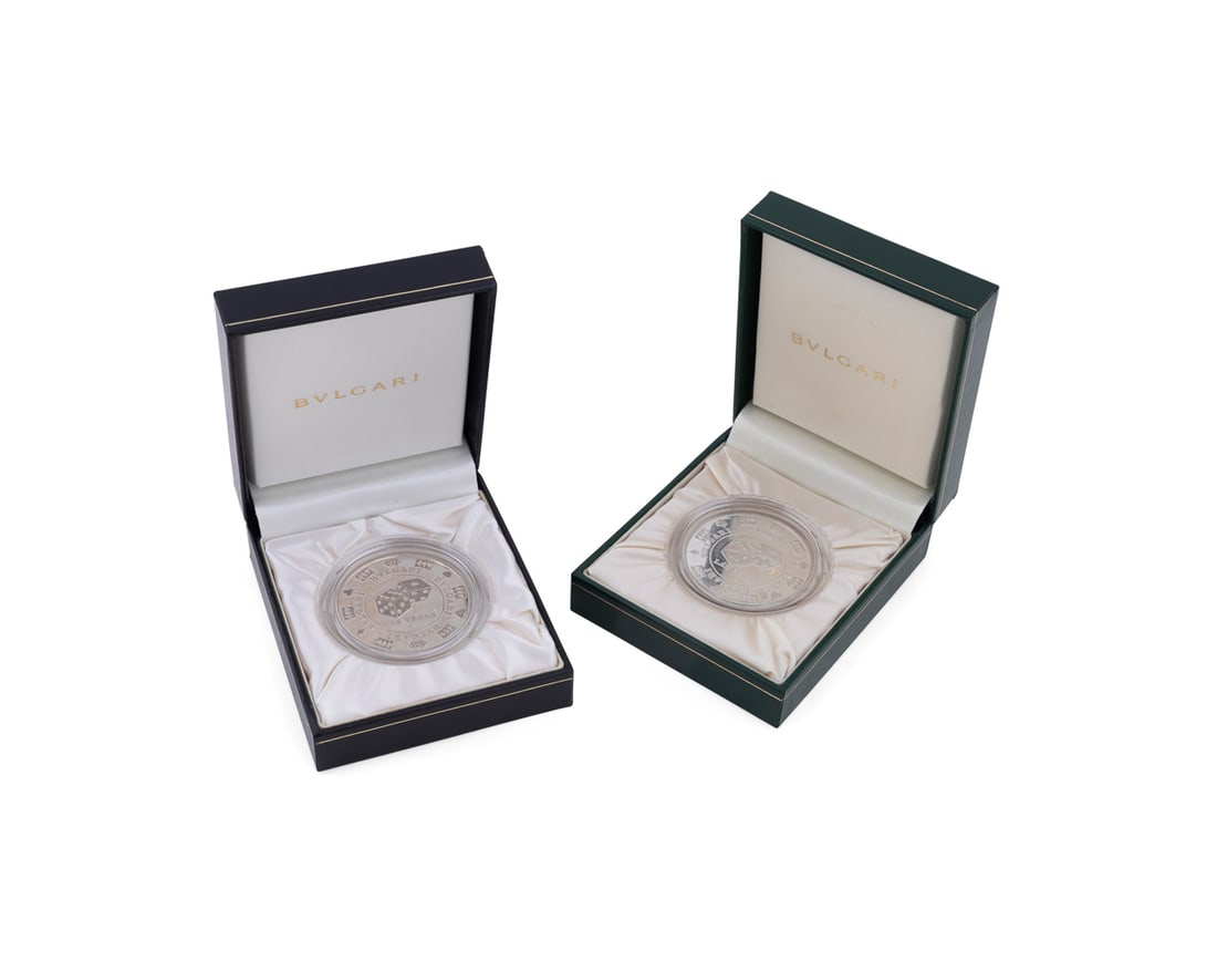 Pair of Bvlgari Sterling Casino Chip Paperweights: Bvlgari (Italian, founded 1884), 1996 and 1999 -2000. Pair of sterling silver casino chip coin paperweights, depicting roulette on one side and dice on the reverse; both are encased in acrylic sleeves