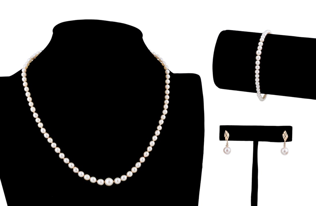Three Piece Cultured Pearl Jewelry Set: Comprising a graduated necklace and bracelet with 14k yellow gold clasp and pair of foliate motif earrings with pearl drops in 14k yellow gold. Both clasps stamped 14k and earring posts and backs stam