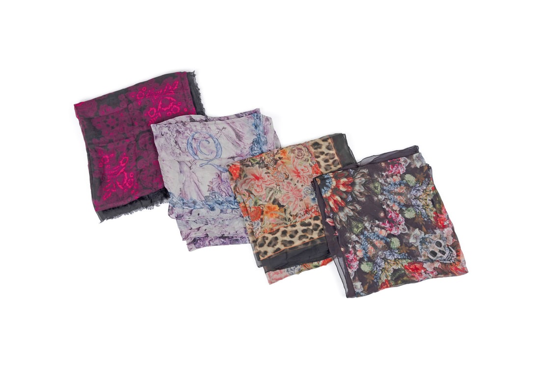 Alexander McQueen, Four Scarves, Floral: Alexander McQueen (British, founded 1992). Four scarves with floral motifs comprising a "Folk Flowers" scarf in pink and black, 90% model 10% cashmere, a purple 100% silk scarf, "Patchwork Circle Skul