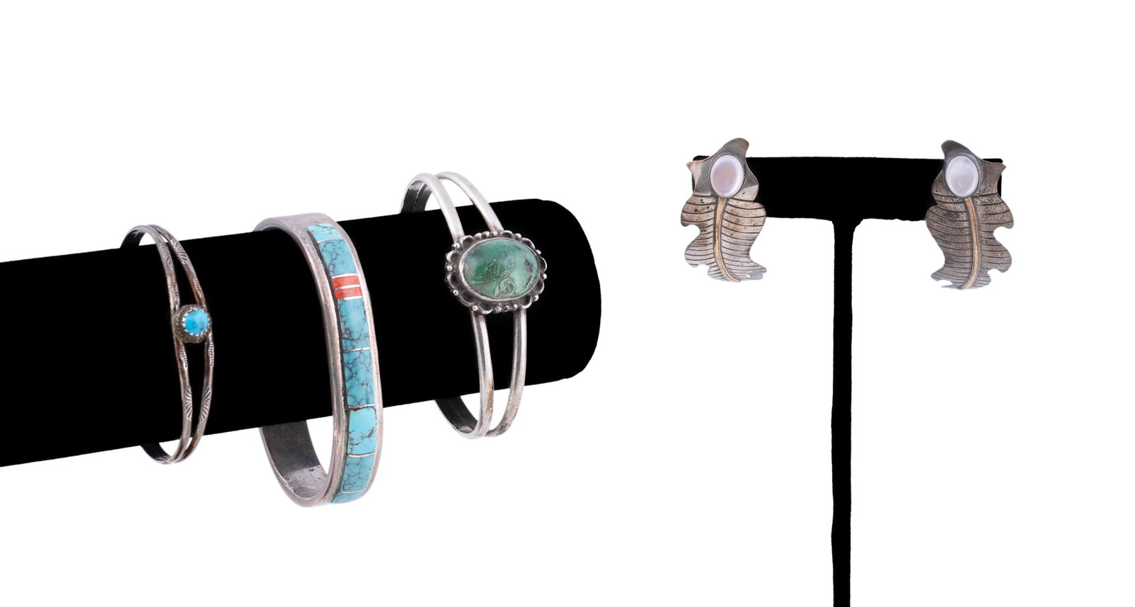 Four Southwestern Sterling Silver Bracelets and Earrings: Including one cuff bracelet of double bands centering on an oval cabochon green turquoise within shell and bead border, one cuff bracelet of double bands centering on a round cabochon blue turquoise w