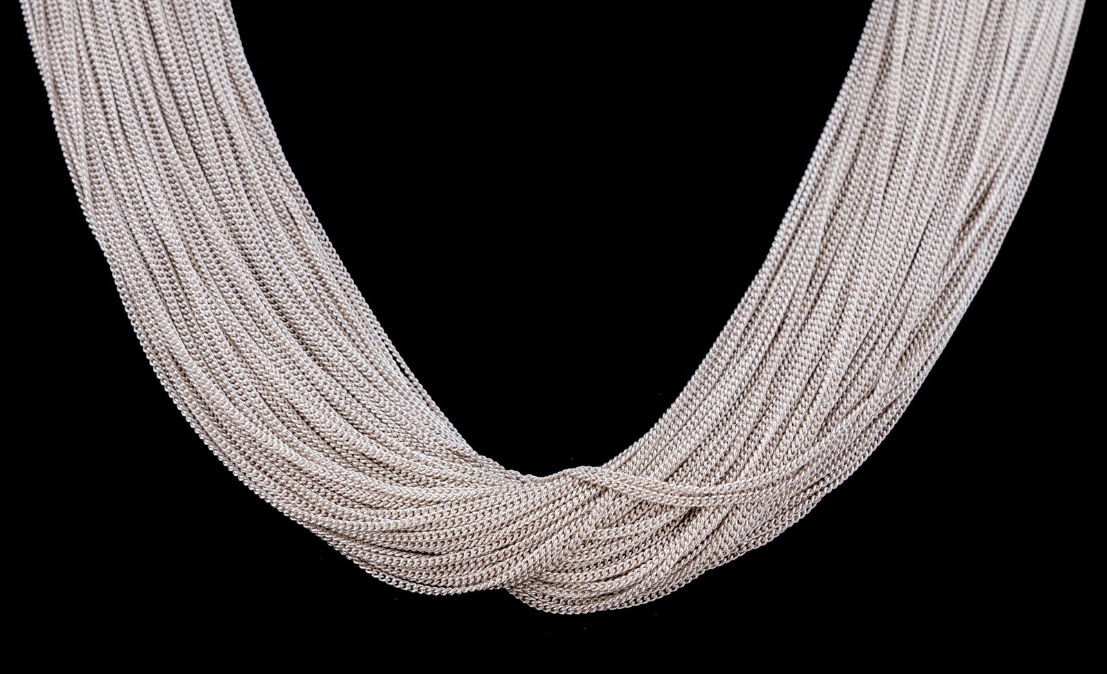 Sterling Silver Chain Necklace: Composed of numerous fine curb link chains with polished silver spring clasp. Stamped '925' and 'ITALY'. Approximate dimensions: Length: 17 in. total weight 98.46 grams. Provenance: Private Collection