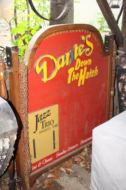 Red Dante's Down the Hatch Sign: Large framed wooden sign with red background with yellow lettering reading "Dante's Down the Hatch". 60"H x 60"W.