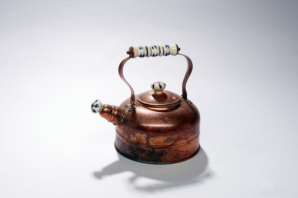 Copper Teapot with Porcelain Handle: Copper tea pot with blue and white porcelain handle and stopper. 9"H x 9 1/2"W